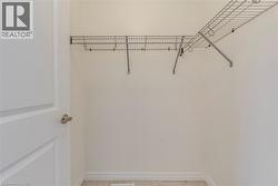 Interior closet featuring wire shelving, neutral wall paint, and baseboard trim - 