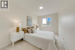 Neutral-toned bedroom featuring carpet flooring and recessed ceiling lighting - 
