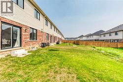 Expansive grassy yard featuring a wood fence perimeter - 