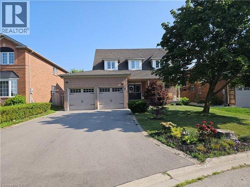 Front of home with large driveway which holds 4 cars and a double garage which holds two more cars. - 20 Bird Court, Cambridge, ON - Outdoor With Facade