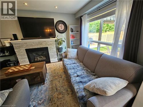 Living room with a glass covered fireplace, and recessed lighting - 20 Bird Court, Cambridge, ON - Indoor Photo Showing Living Room With Fireplace
