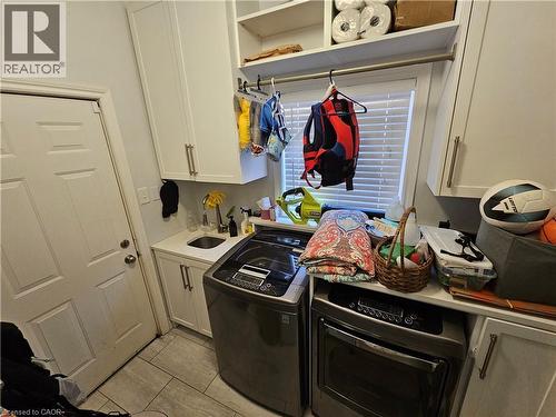 Laundry area with cabinet space, and independent washer and dryer - 20 Bird Court, Cambridge, ON - Indoor