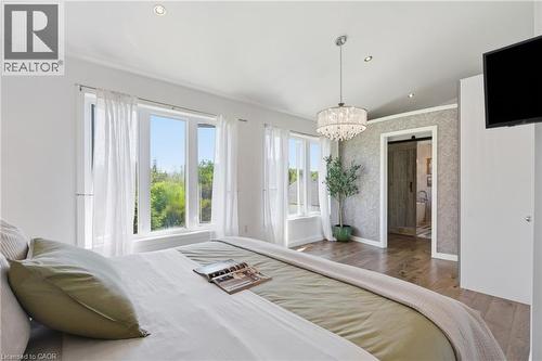 Bright room featuring multiple windows, wood-finish flooring, recessed lighting, and a crystal chandelier - 5779 Third Line, Guelph/Eramosa, ON - Indoor Photo Showing Bedroom