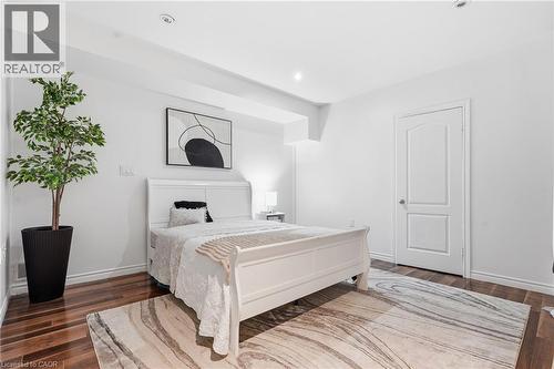 Bedroom featuring wood-finish flooring, recessed lighting, and a white paneled door - 5779 Third Line, Guelph/Eramosa, ON - Indoor Photo Showing Bedroom