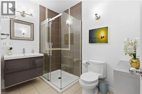 Modern bathroom featuring a glass-enclosed shower with brown tiled walls - 5779 Third Line, Guelph/Eramosa, ON - Indoor Photo Showing Bathroom
