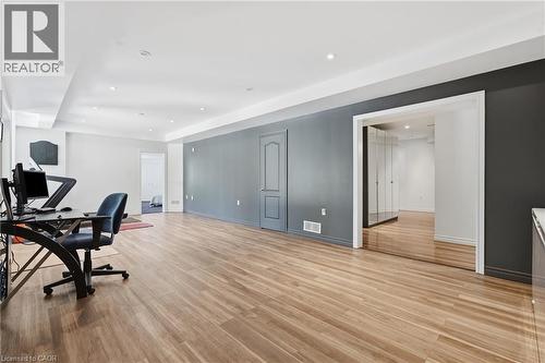 Spacious room featuring wood-finish flooring, recessed lighting, and a neutral wall color palette with an accent wall - 5779 Third Line, Guelph/Eramosa, ON - Indoor