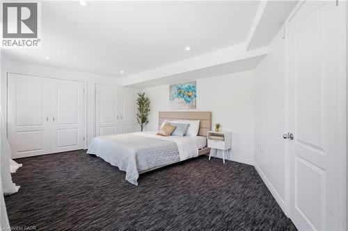 Spacious room featuring textured dark carpeting, recessed lighting, white walls, and multiple panel doors - 5779 Third Line, Guelph/Eramosa, ON - Indoor Photo Showing Bedroom