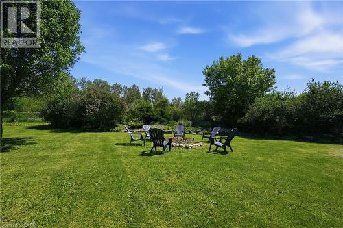 Expansive lawn featuring a built-in stone fire pit - 5779 Third Line, Guelph/Eramosa, ON - Outdoor
