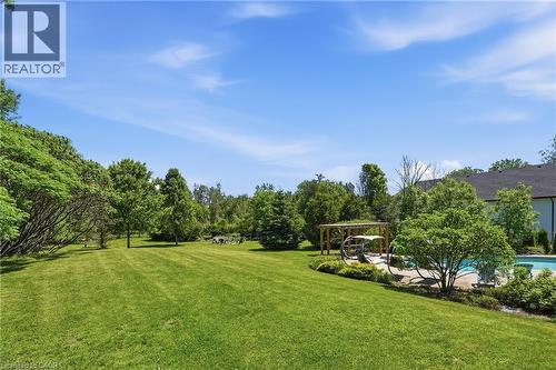Expansive green lawn with mature trees and a dedicated pool area - 5779 Third Line, Guelph/Eramosa, ON - Outdoor