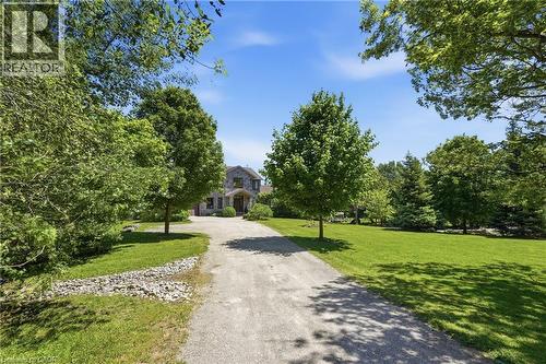 Stone-clad residence featuring a gabled roofline and covered entry - 5779 Third Line, Guelph/Eramosa, ON - Outdoor
