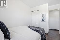 White-painted room featuring a bi-fold closet and dark wood-finish flooring - 