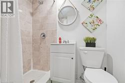 Shower with light-colored tile surround and chrome fixtures - 