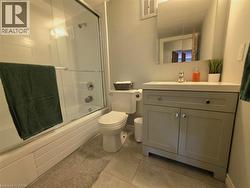 Bathroom featuring a neutral-toned vanity with a white countertop and integral sink - 