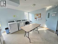 On-site laundry room featuring multiple washing machines and dryers - 