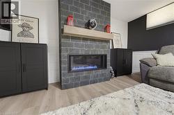 Floor-to-ceiling fireplace featuring slate tile surround and a natural wood mantel - 