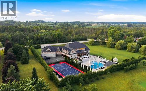 Expansive property featuring a large residence with stone and stucco exterior - 7009 Wellington Rd 34, Puslinch, ON - Outdoor With View