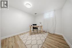 Bright room with wood-finish flooring, crisp white walls, and a recessed window - 
