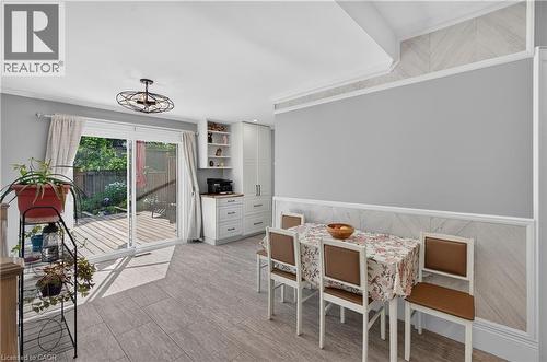 Sliding glass doors opening to an exterior wood deck, complemented by wood-finish flooring - 9 Davidson Street, Cambridge, ON - Indoor Photo Showing Other Room