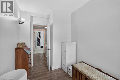 Hallway featuring wood-finish flooring, white baseboards, and a sconce light fixture - 9 Davidson Street, Cambridge, ON - Indoor Photo Showing Other Room