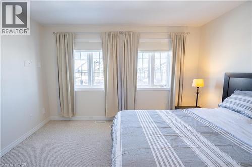 Neutral-toned walls complement light-colored carpeting - 44 Medici Lane, Hamilton, ON - Indoor Photo Showing Bedroom