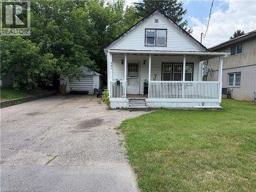 White siding exterior with a covered front porch featuring white railings - 391 Lawrence Avenue, Kitchener, ON - Outdoor With Deck Patio Veranda
