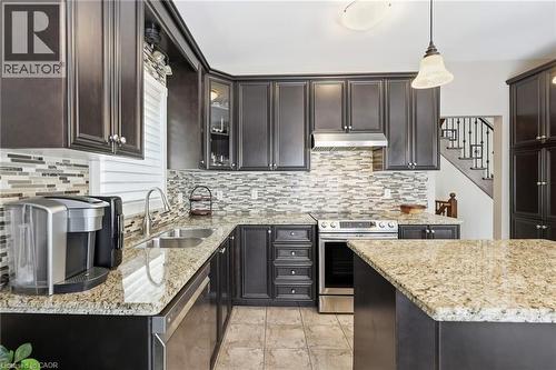 Kitchen featuring dark wood-finish cabinetry and light-toned granite countertops - 1332 Baseline Road, Stoney Creek, ON - Indoor Photo Showing Kitchen With Double Sink With Upgraded Kitchen