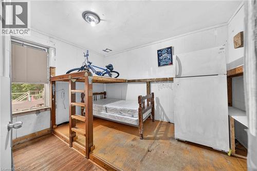 Raised wood-frame sleeping platform with integrated ladder and under-platform space - 817 King Street E, Hamilton, ON 