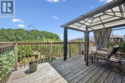 Expansive outdoor deck featuring wood-finish decking and perimeter wood railing - 