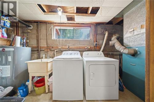 Dedicated laundry area featuring a utility sink, water heater, and mechanical systems - 1598 Highway No 6, Hamilton, ON - Indoor Photo Showing Laundry Room