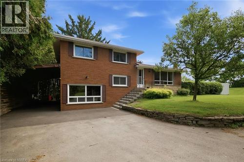 Brick exterior with brown shutters and white window frames - 1598 Highway No 6, Hamilton, ON - Outdoor