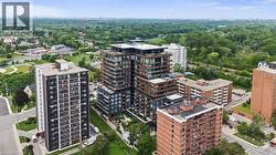 Modern high-rise residential building with balconies and a flat roofline - 