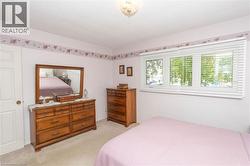 Wall-to-wall carpeting with a three-panel window featuring horizontal blinds - 