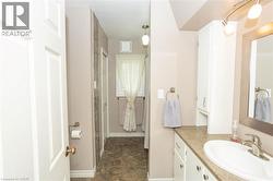 Bathroom vanity with a white basin sink, brushed nickel faucet, and integrated countertop - 