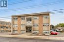 Three-story building featuring a concrete facade with stone veneer accents, multiple windows, and a prominent main entrance - 237 Mohawk Road E Unit# 16, Hamilton, ON  - Outdoor 