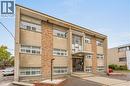 Three-story building with a light brick facade and stone-clad accents - 237 Mohawk Road E Unit# 16, Hamilton, ON  - Outdoor 