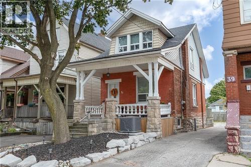 Brick and siding exterior with a covered front porch featuring stone balusters and columns - 37 Cliff Avenue Unit# Upper, Hamilton, ON - Outdoor With Facade