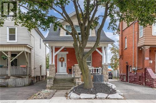 Red brick facade with stone accents and a covered front porch - 37 Cliff Avenue Unit# Upper, Hamilton, ON - Outdoor With Facade