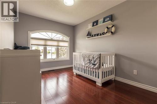 Hardwood flooring complemented by light gray walls - 44 Lemon Grass Street, Kitchener, ON - Indoor Photo Showing Bedroom