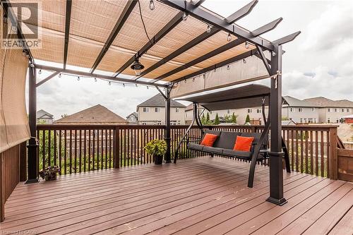 Spacious outdoor deck featuring wood-finish flooring, a full-height wood railing, and a pergola with a retractable shade canopy - 44 Lemon Grass Street, Kitchener, ON - Outdoor With Deck Patio Veranda With Exterior