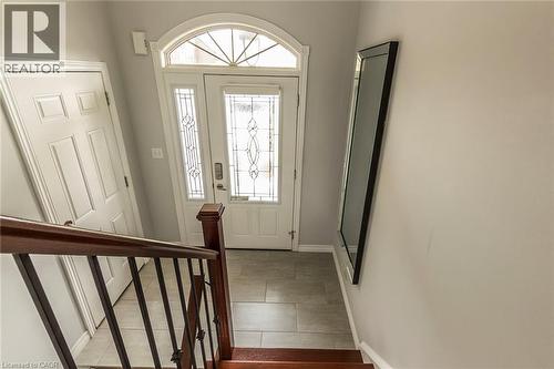 Entryway featuring a white door with decorative glass inserts, an arched transom window, and a tiled floor - 44 Lemon Grass Street, Kitchener, ON - Indoor Photo Showing Other Room
