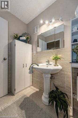 Pedestal sink with chrome fixtures and a mirrored medicine cabinet - 75 Hazelglen Drive Unit# 308, Kitchener, ON - Indoor Photo Showing Bathroom