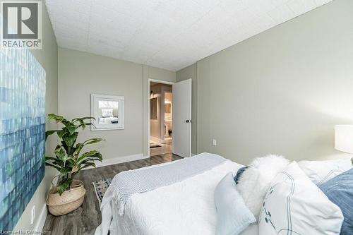 Interior room featuring light-toned walls, wood-finish flooring, and a flat white ceiling - 75 Hazelglen Drive Unit# 308, Kitchener, ON - Indoor Photo Showing Bedroom