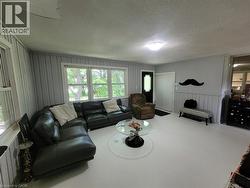 Living area featuring light-colored flooring and paneling - 