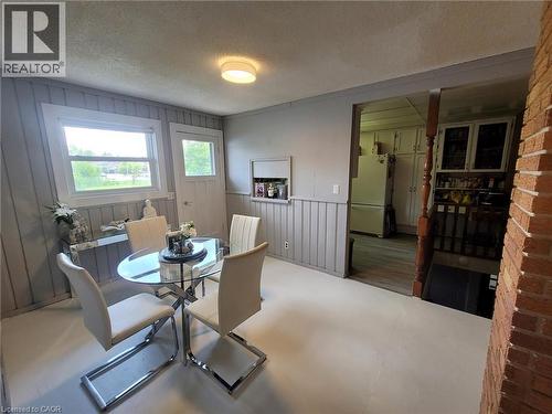 Dining area featuring a window, painted wood paneling, and a flush-mount ceiling light - 879 West 5Th Street, Hamilton, ON - Indoor Photo Showing Dining Room