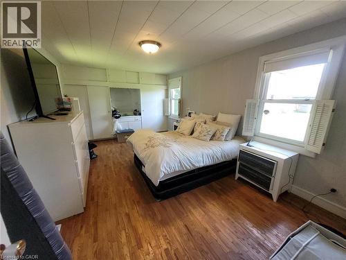 Hardwood flooring throughout the room with a paneled ceiling - 879 West 5Th Street, Hamilton, ON - Indoor Photo Showing Bedroom