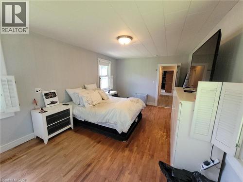 Spacious room featuring wood-finish flooring, light grey walls, and a recessed ceiling light fixture - 879 West 5Th Street, Hamilton, ON - Indoor Photo Showing Bedroom