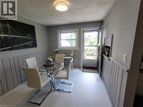 Dining area featuring painted board and batten wainscoting and light-colored flooring - 879 West 5Th Street, Hamilton, ON - Indoor Photo Showing Dining Room