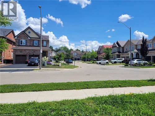 Residential street featuring paved roadways and concrete sidewalks - 879 West 5Th Street, Hamilton, ON - Outdoor With Facade