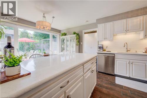 Kitchen island featuring a light-toned countertop, white cabinetry, and wood-finish flooring - 41 Mcniven Road, Ancaster, ON - Indoor Photo Showing Kitchen With Upgraded Kitchen