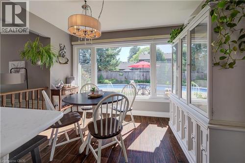 Dining area with wood-finish flooring and a central chandelier - 41 Mcniven Road, Ancaster, ON - Indoor Photo Showing Dining Room